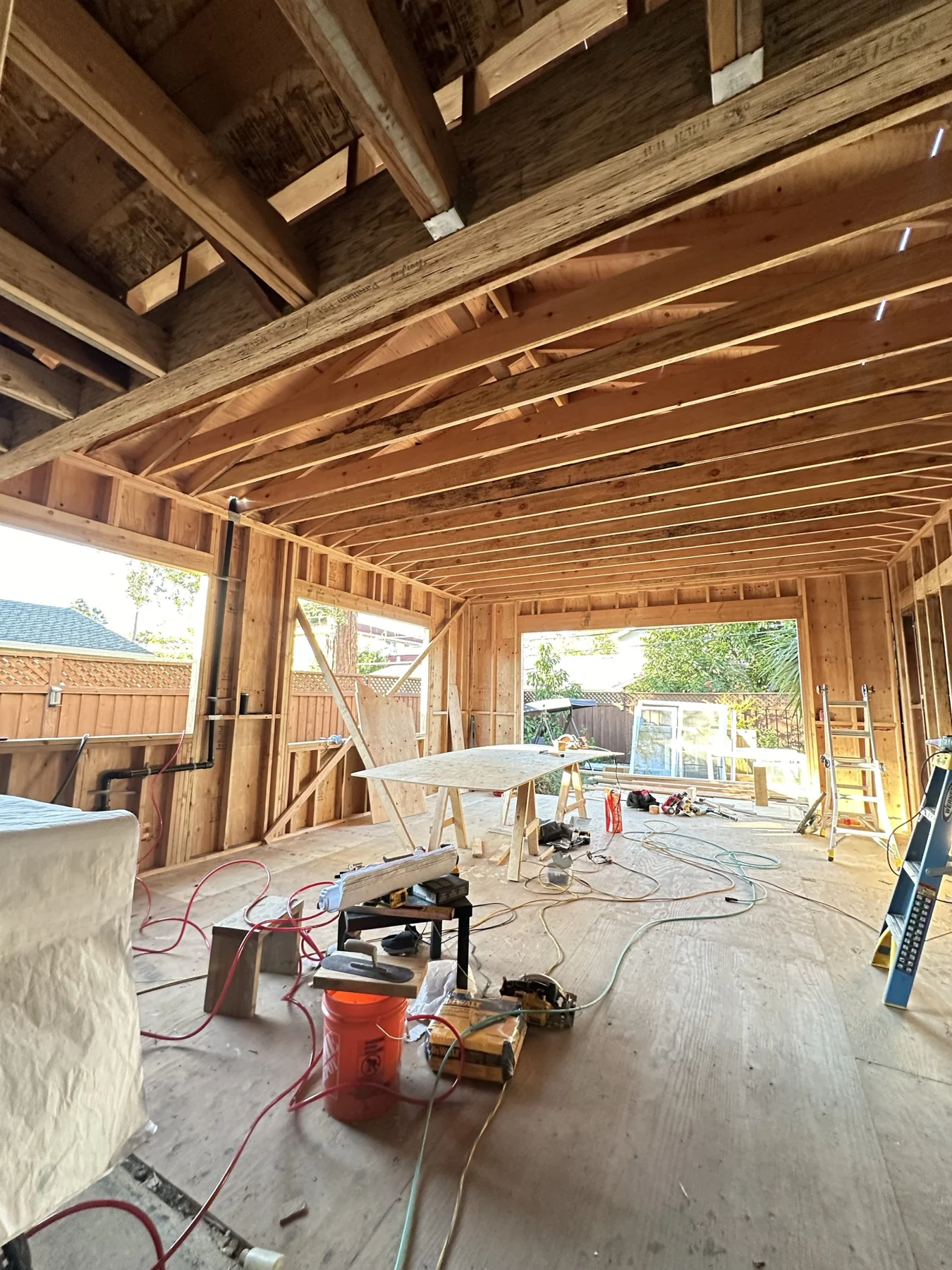 Open wall and ceiling framing inside a house addition.